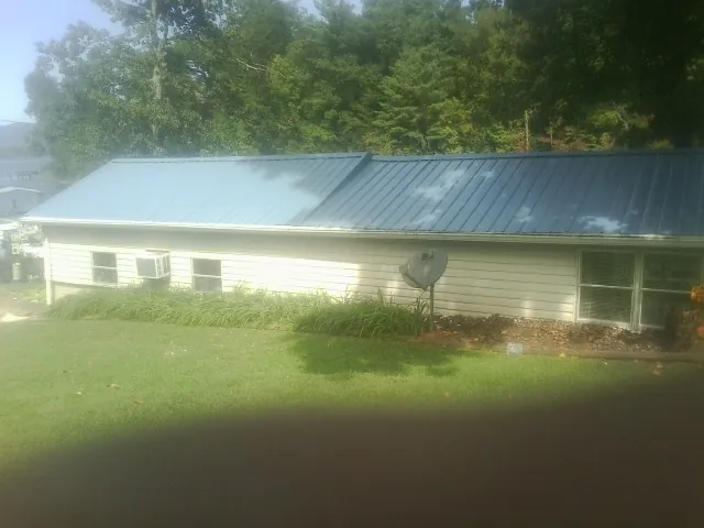 Blue metal roof running the length of a single story home in Marion